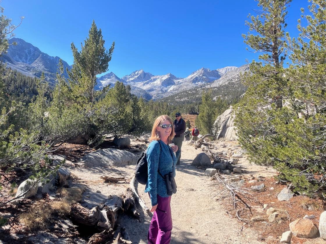 Photo of Laura Schare and a man hiking in the mountains